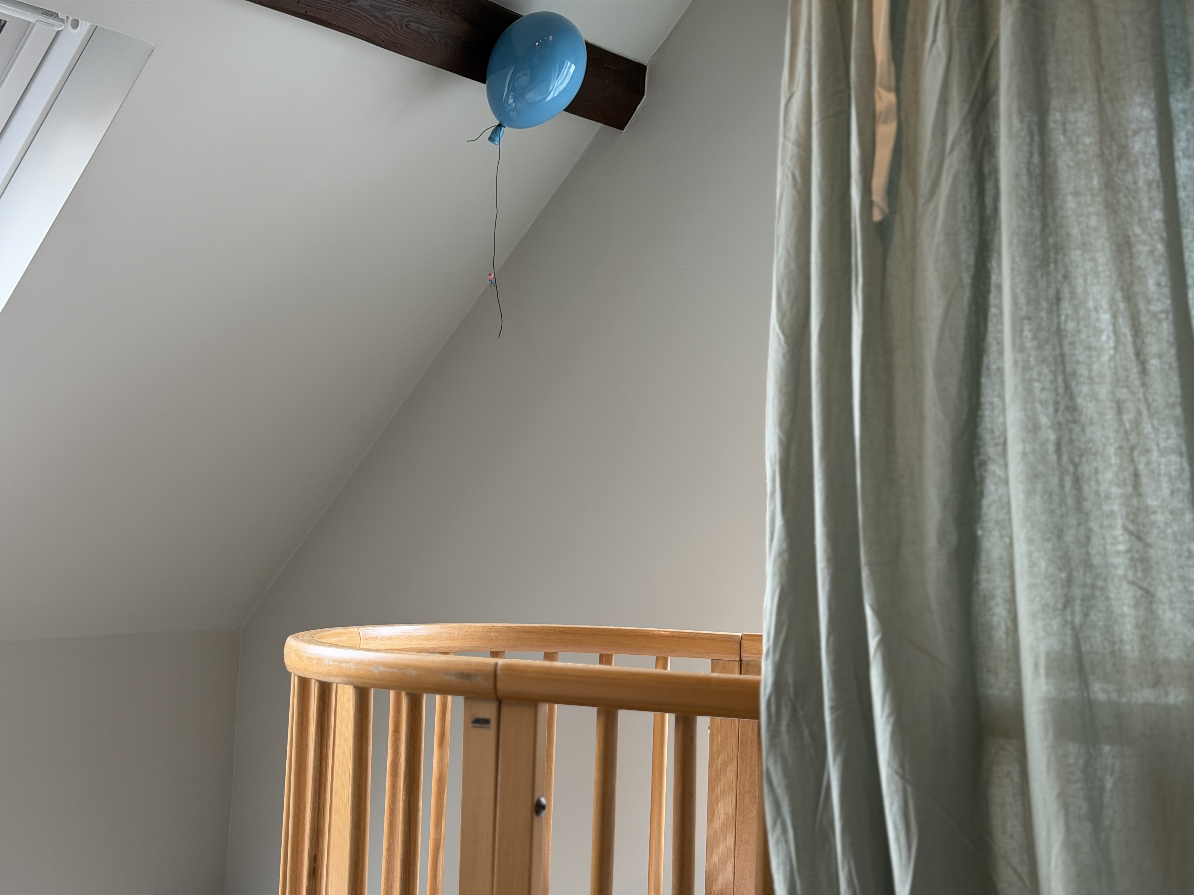 A child's bedroom with a balloon, peaceful and secure.