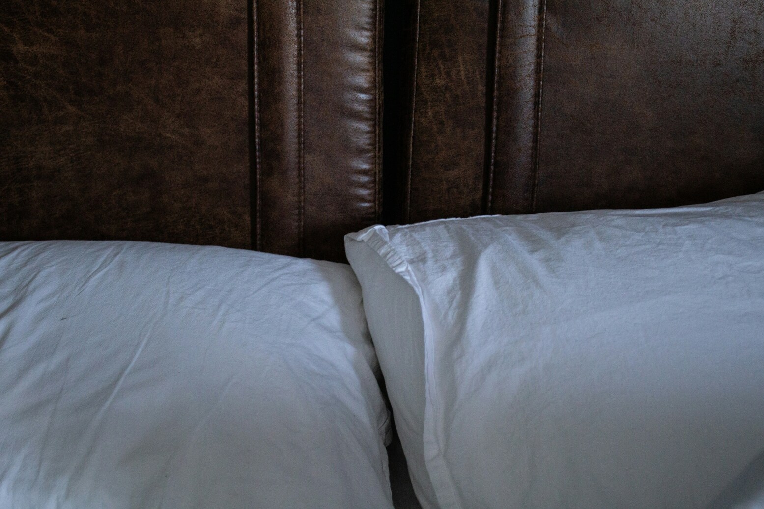 Pillows in a bed, representing the shared sleep space of partners